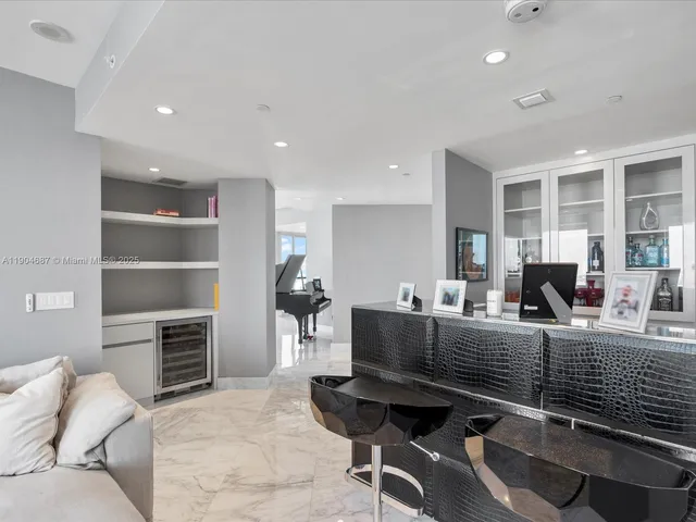 a living room with furniture flat screen tv and a window