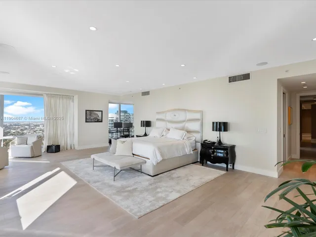 a large bedroom with a bed and a couch