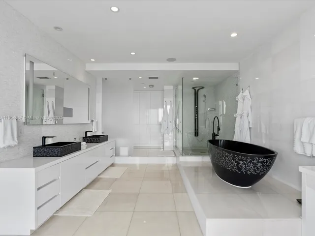 a bathroom with a sink a mirror and a shower