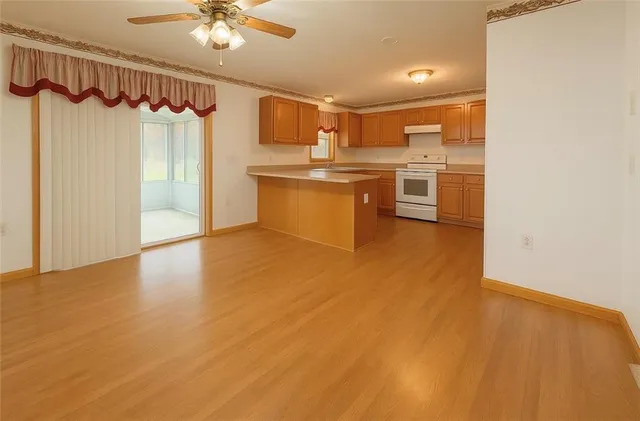 a view of kitchen with granite countertop cabinets and refrigerator