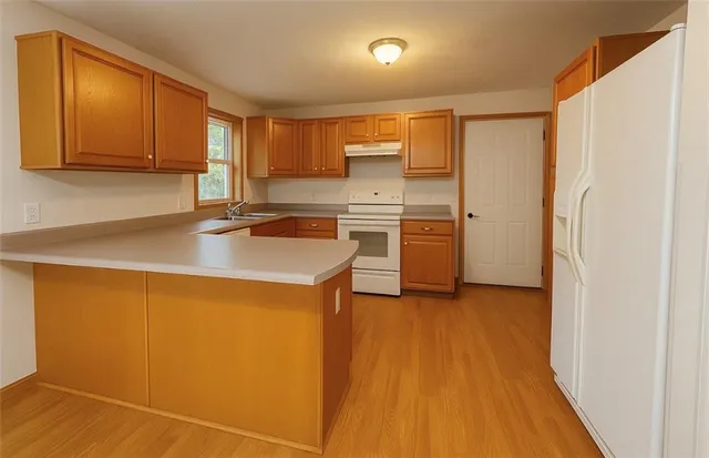 a kitchen with stainless steel appliances a refrigerator sink and cabinets