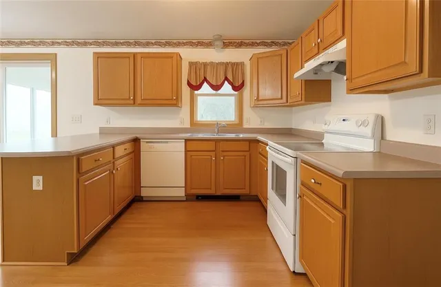 a kitchen with stainless steel appliances granite countertop a sink and cabinets