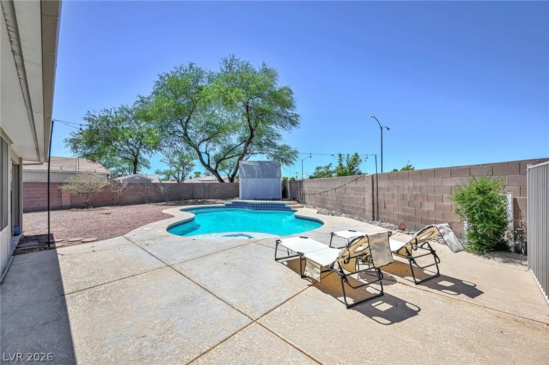 1234 Sunfire Street Henderson, NV 89014 - Photo 34 of 40 A tranquil backyard oasis featuring a free-form pool and ample patio space for leisure.
