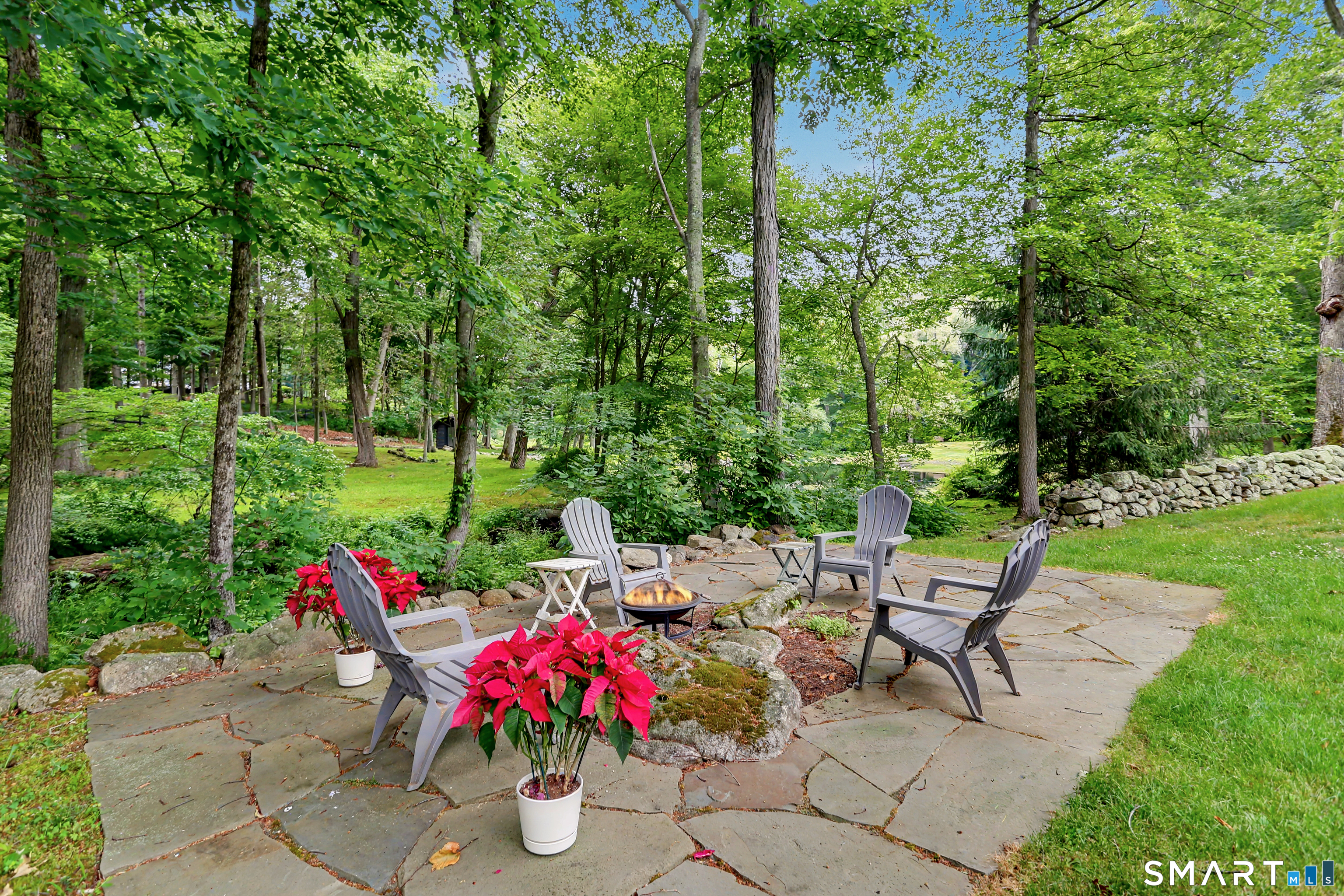 108 Logan Road New Canaan, CT 06840 - Photo 35 of 40 a view of a dining table and chairs in the garden