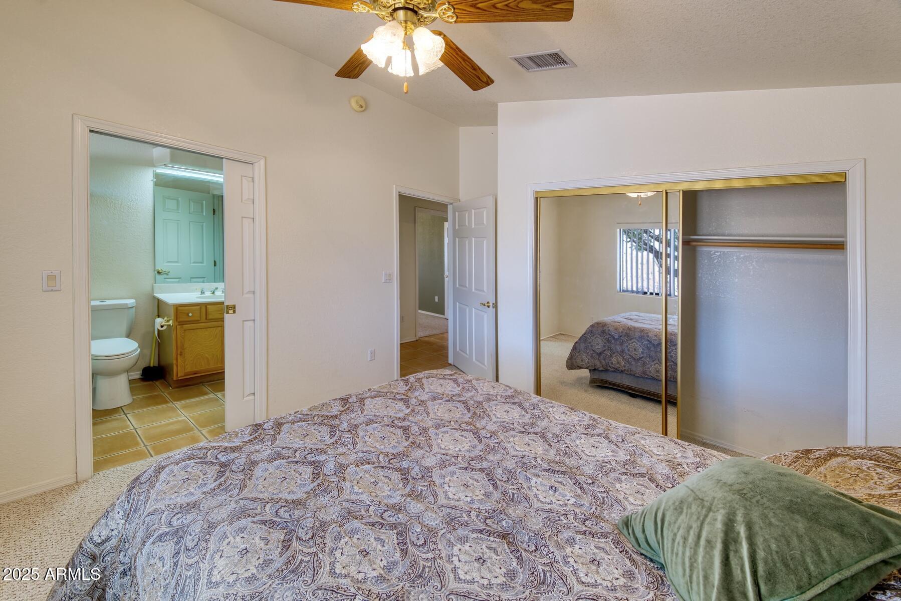 2290 North Ranch Trail Huachuca City, AZ 85616 - Photo 14 of 28 a bedroom with a bed and a chandelier