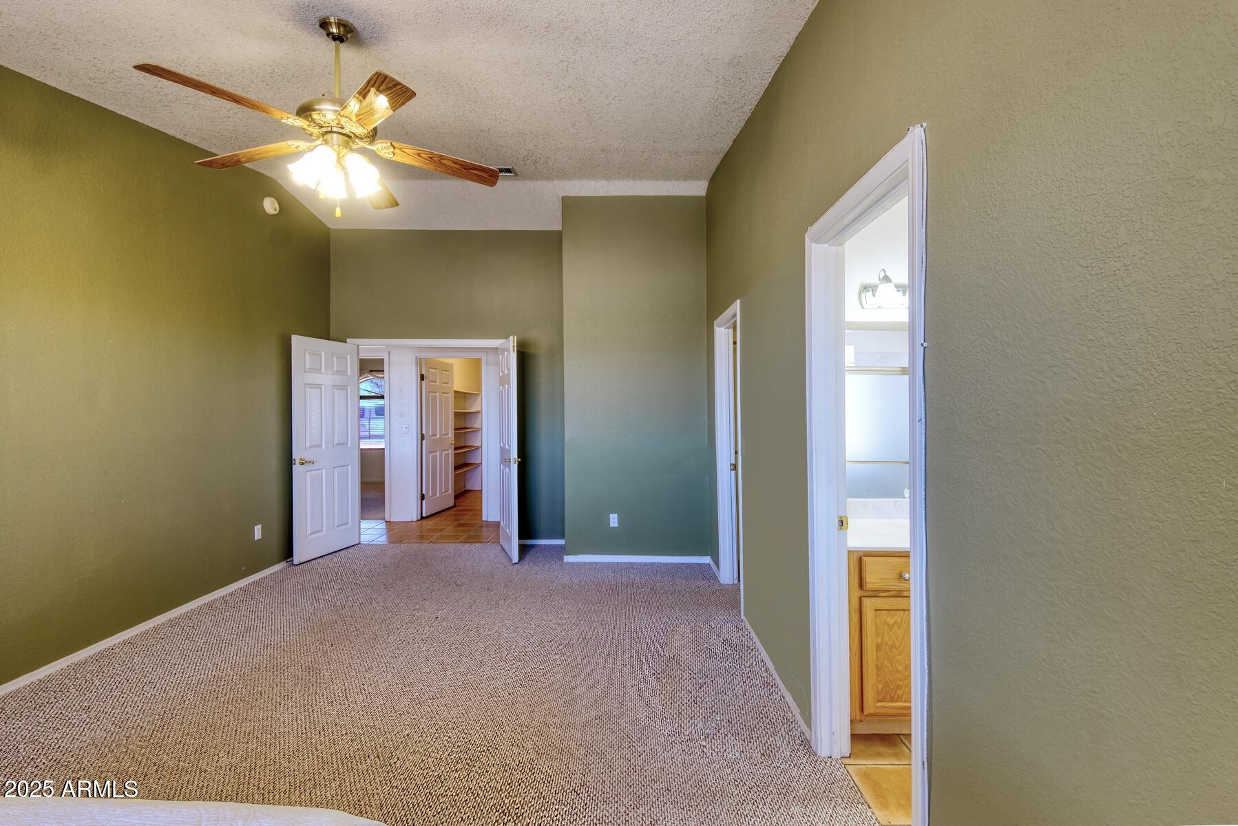 2290 North Ranch Trail Huachuca City, AZ 85616 - Photo 18 of 28 a view of a hallway with a chandelier fan