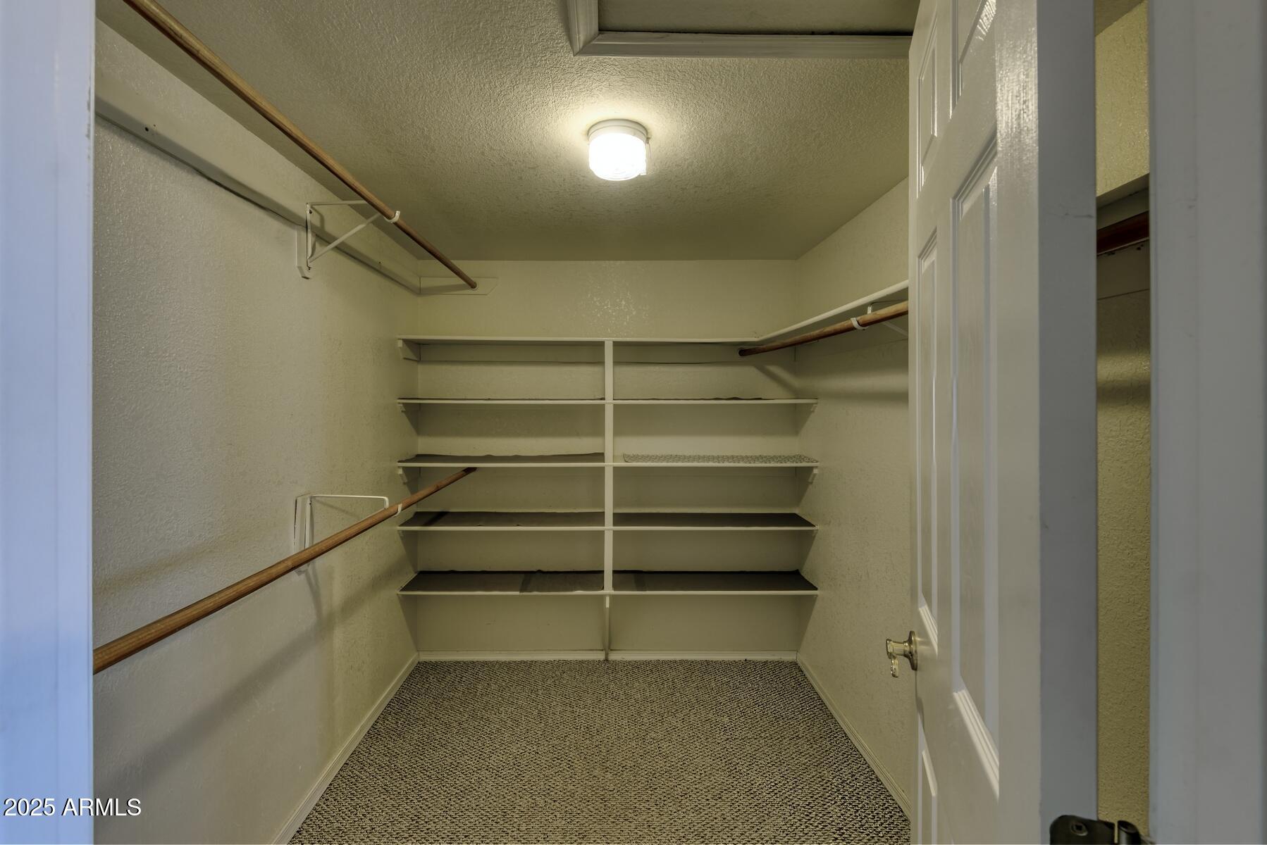 2290 North Ranch Trail Huachuca City, AZ 85616 - Photo 19 of 28 a view of walk in closet with empty racks