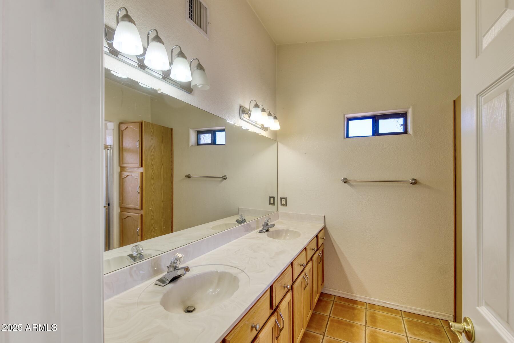 2290 North Ranch Trail Huachuca City, AZ 85616 - Photo 20 of 28 a bathroom with a sink and a mirror