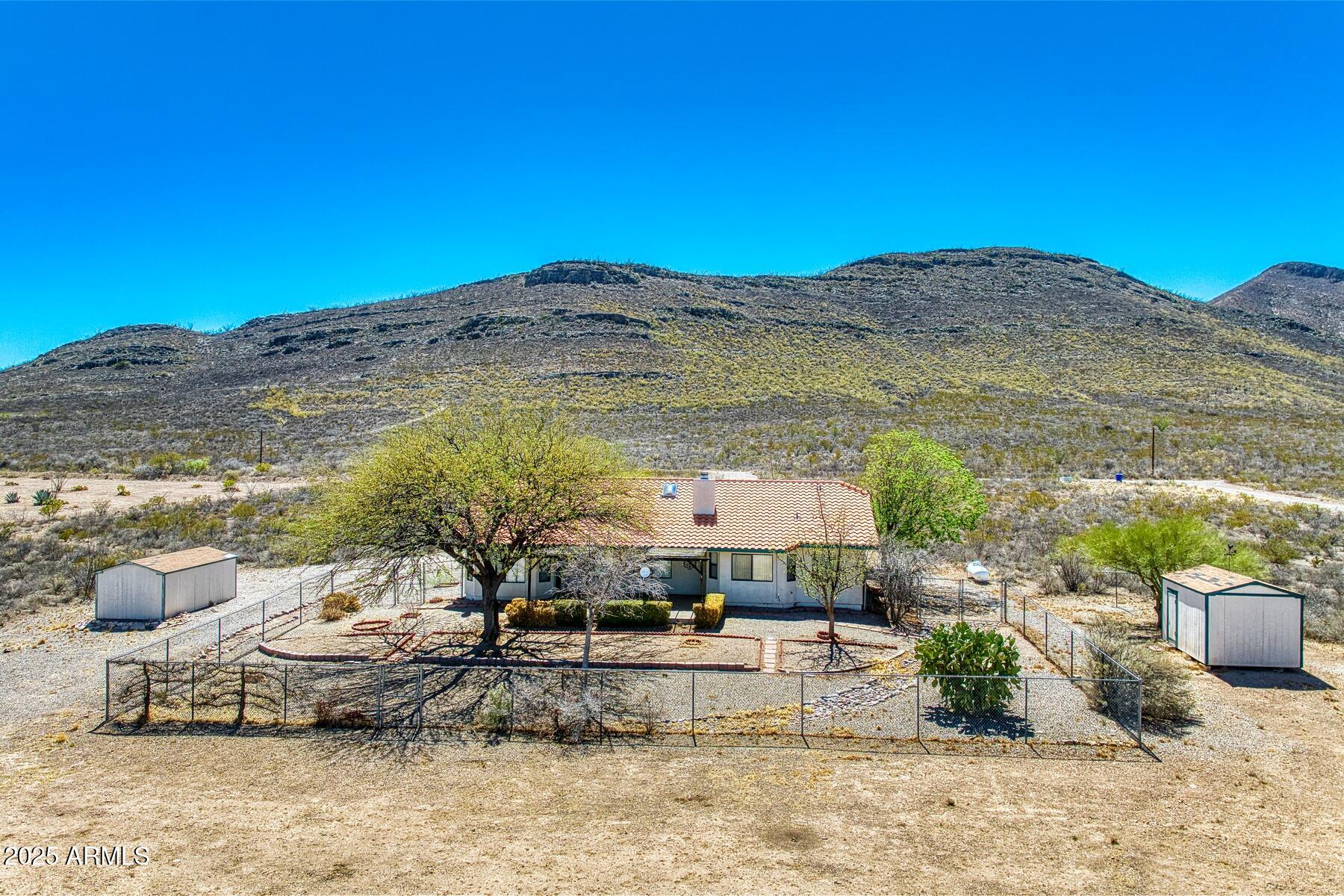 2290 North Ranch Trail Huachuca City, AZ 85616 - Photo 2 of 28 a view of a terrace with a table and chairs