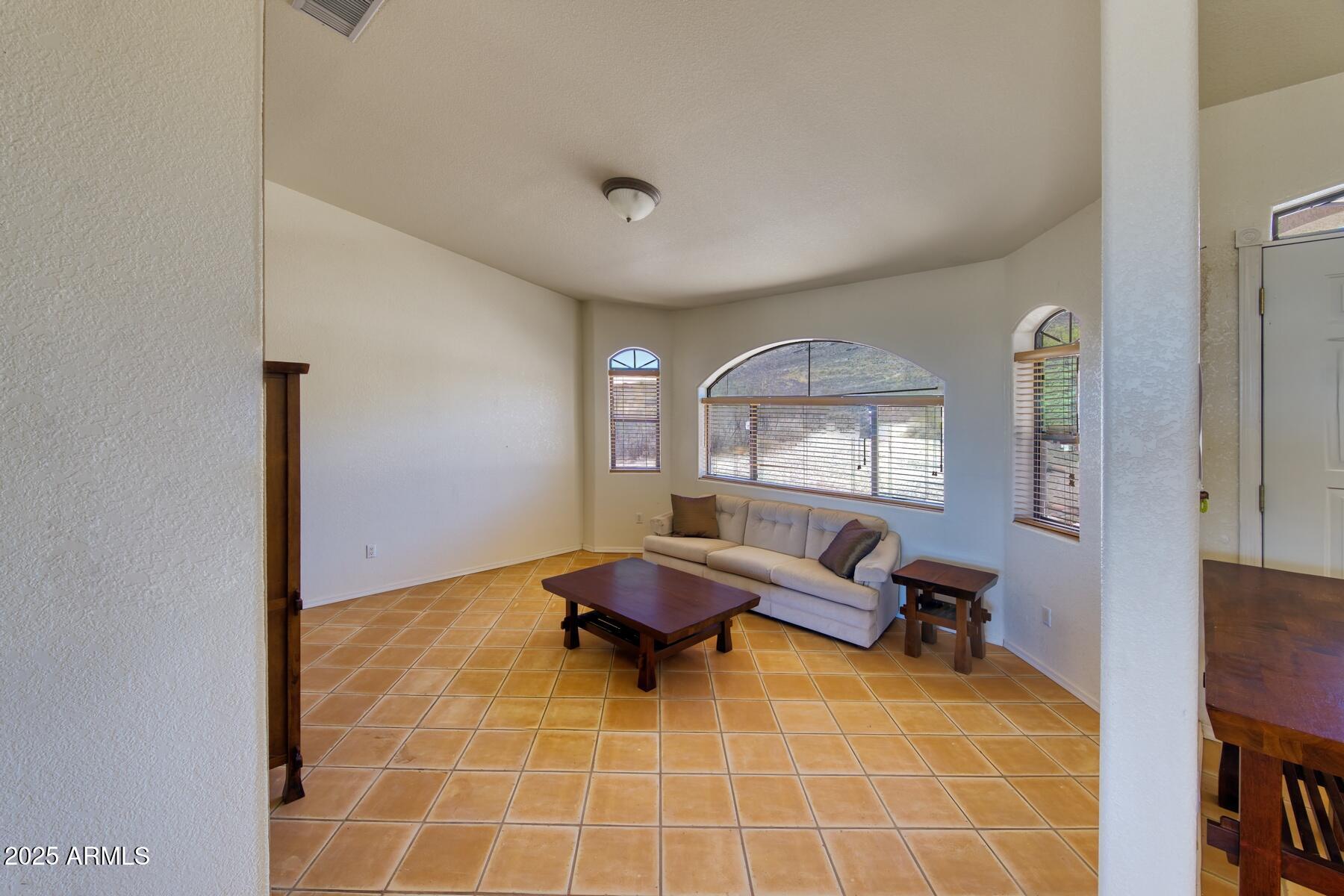 2290 North Ranch Trail Huachuca City, AZ 85616 - Photo 7 of 28 a living room with furniture and a window