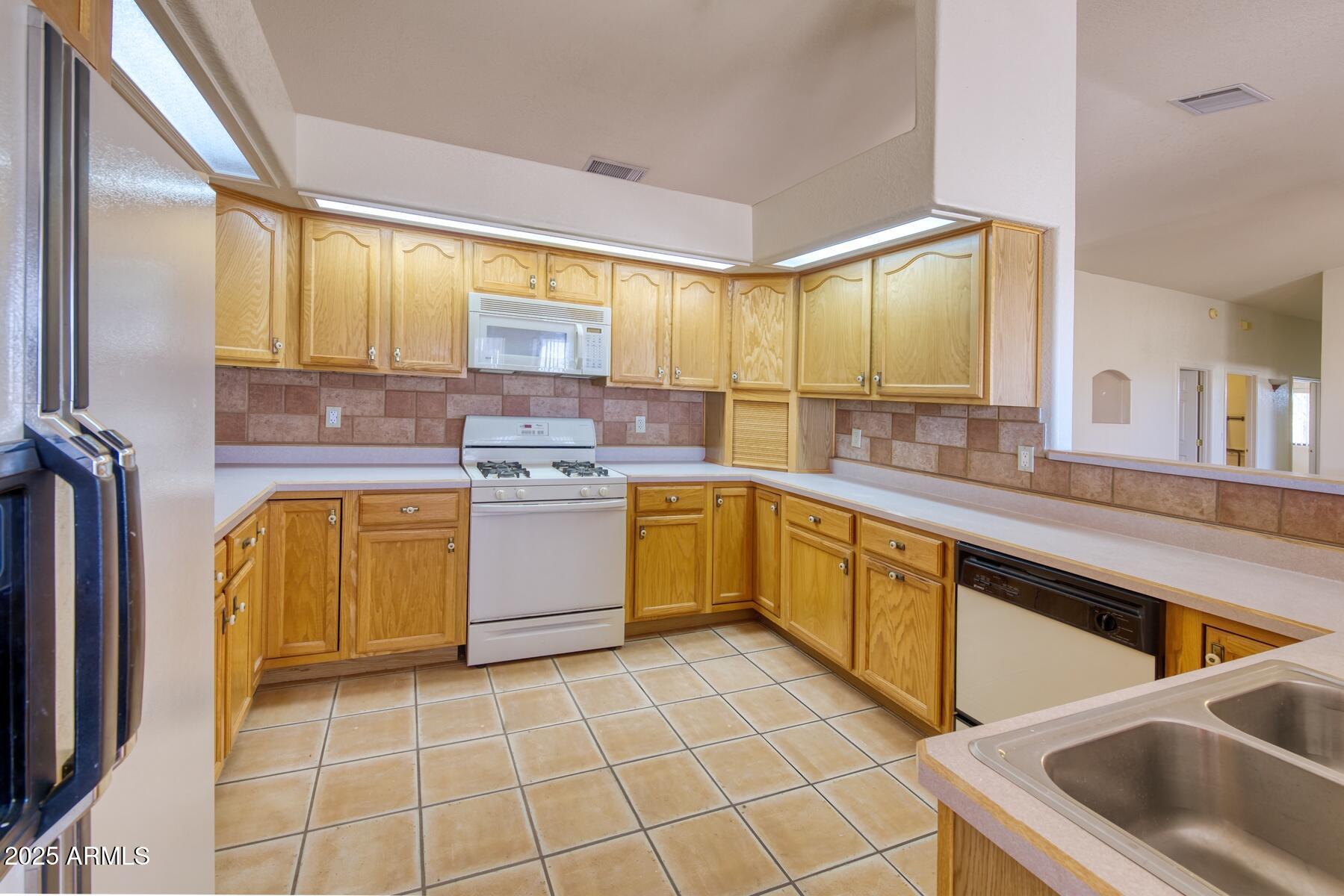 2290 North Ranch Trail Huachuca City, AZ 85616 - Photo 9 of 28 a kitchen with a stove sink and cabinets