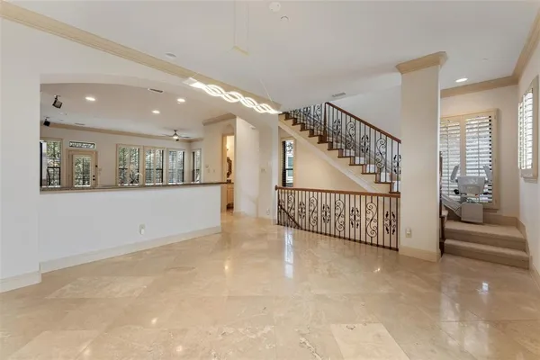 a view of a hallway with wooden floor and windows
