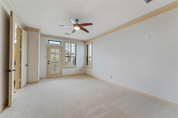 an empty room with closet and windows