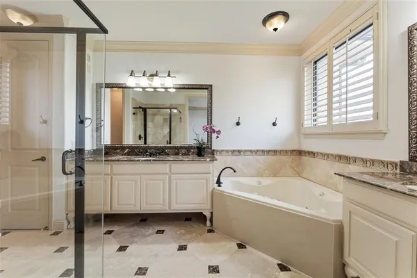 a bathroom with a double vanity sink mirror and shower