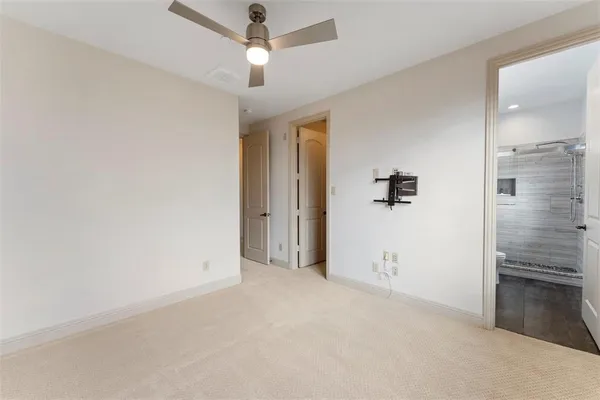 a bathroom with a granite countertop sink a toilet a mirror and shower