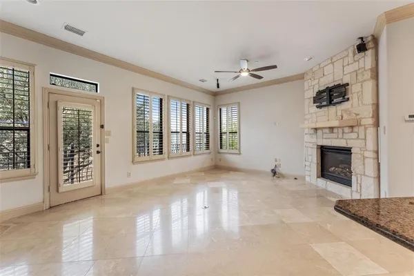 a view of an empty room with a fireplace and a window