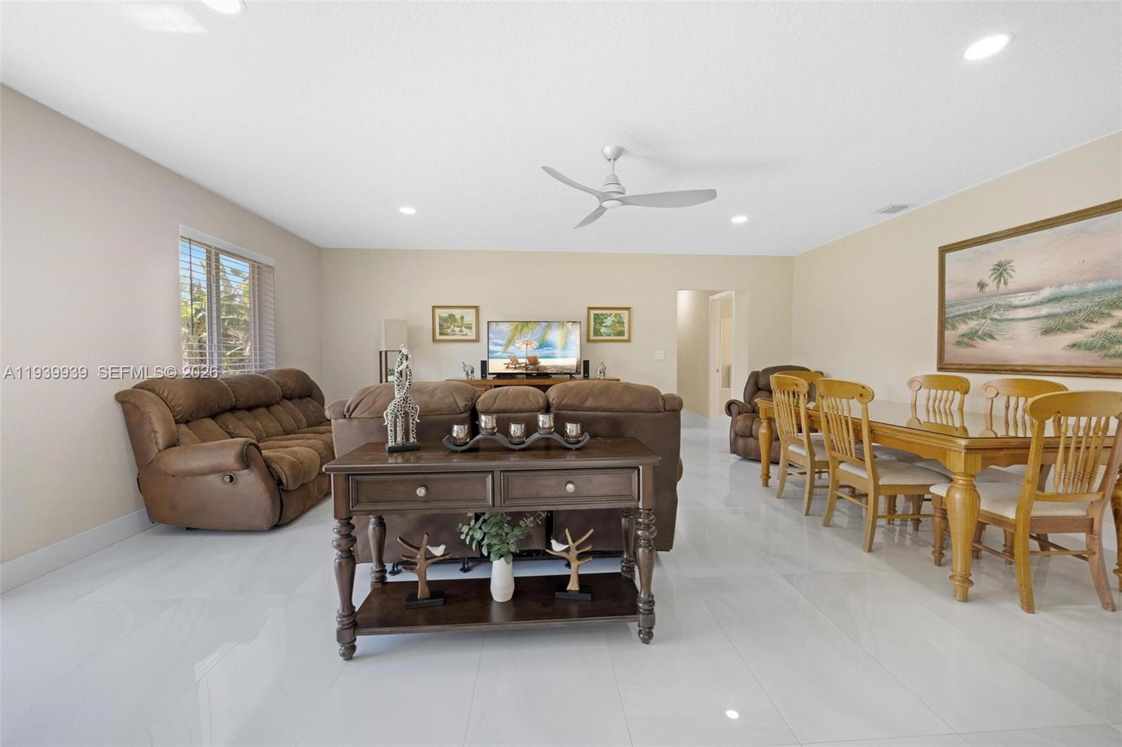12851 Luray Road Southwest Ranches, FL 33330 - Photo 20 of 43 a living room with furniture and a dining table with kitchen appliances