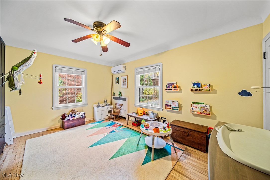2710 Edgehill Road Cleveland, OH 44106 - Photo 17 of 44 Rec room featuring a wall mounted AC, light hardwood / wood-style flooring, and ceiling fan