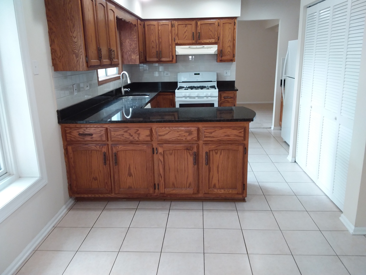 7308 Devereux Road Downers Grove, IL 60516 - Photo 17 of 34 a kitchen with stainless steel appliances a sink a stove a microwave and cabinets