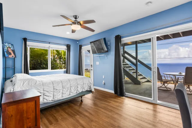 a bedroom with a bed and a large window with outer view