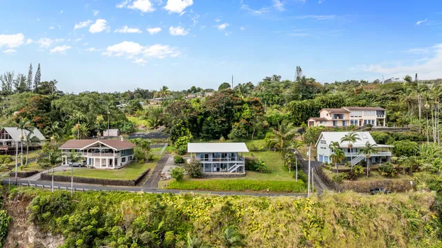 a view of a multi story residential apartment building with a yard