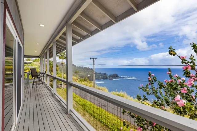 a view of a balcony with wooden floor