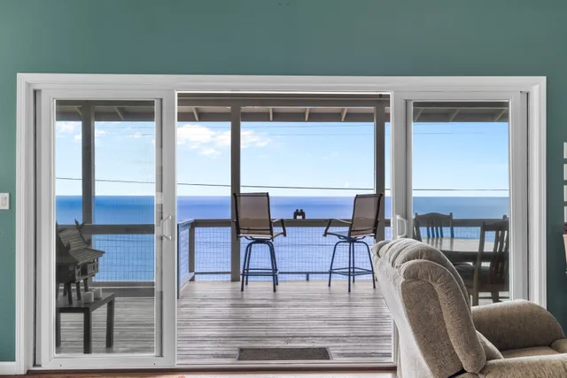 a living room with furniture and a floor to ceiling window