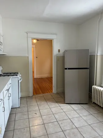 a kitchen with a refrigerator and a stove