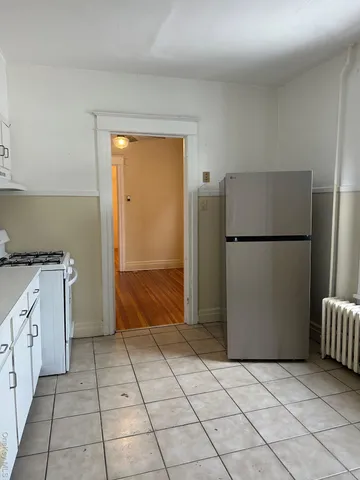 a kitchen with a refrigerator and a stove