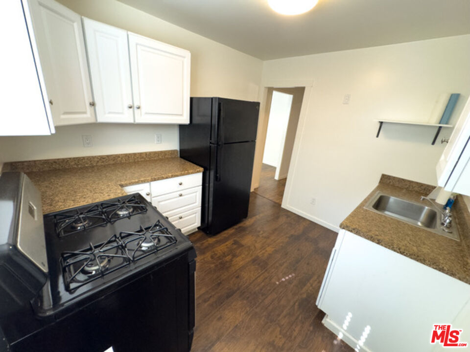 2947 Los Robles Road Thousand Oaks, CA 91362 - Photo 16 of 31 a kitchen with wooden cabinets and a stove top oven