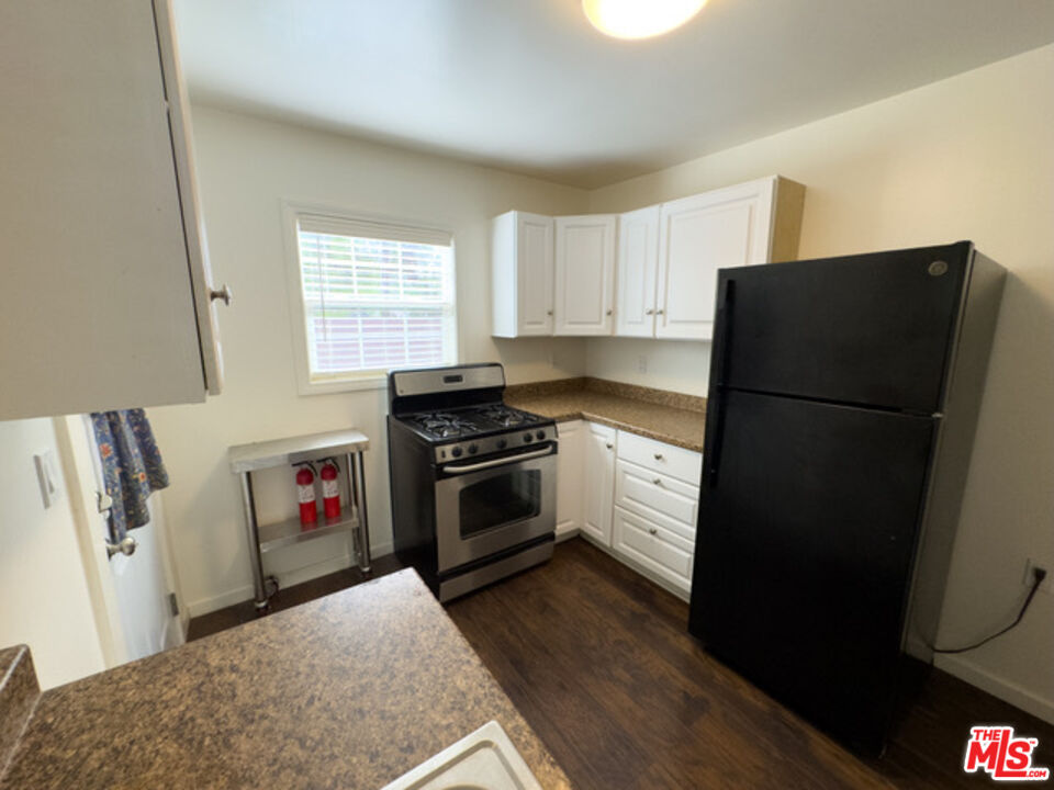 2947 Los Robles Road Thousand Oaks, CA 91362 - Photo 17 of 31 a kitchen with a refrigerator stove and wooden floor