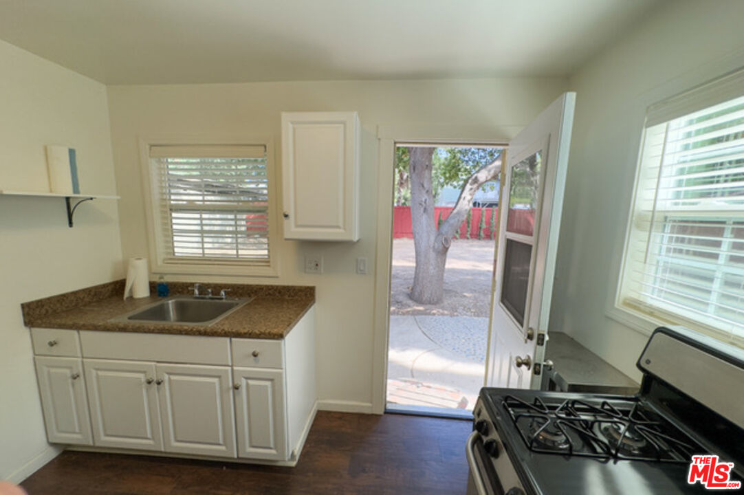 2947 Los Robles Road Thousand Oaks, CA 91362 - Photo 18 of 31 a kitchen with granite countertop a sink stove and cabinets