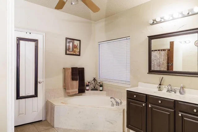 a bathroom with a granite countertop toilet sink and mirror