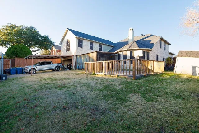 a view of a porch with a table and chairs and floor to ceiling window