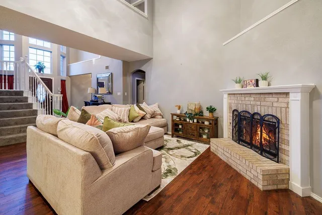 a living room with furniture and a fireplace
