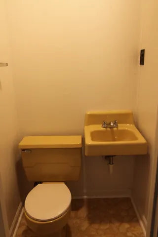 a bathroom with a toilet and a sink