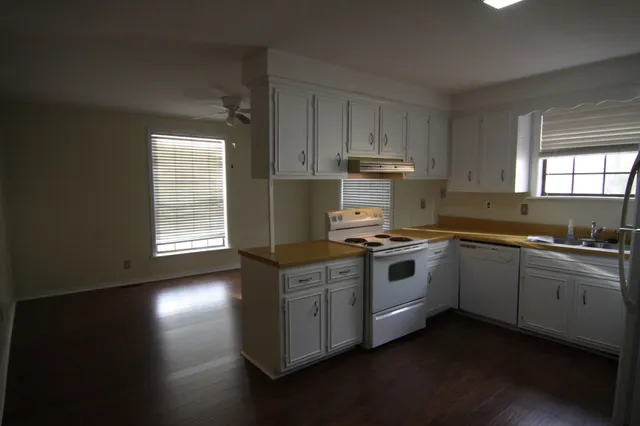 a kitchen with stainless steel appliances a sink a stove a refrigerator and cabinets