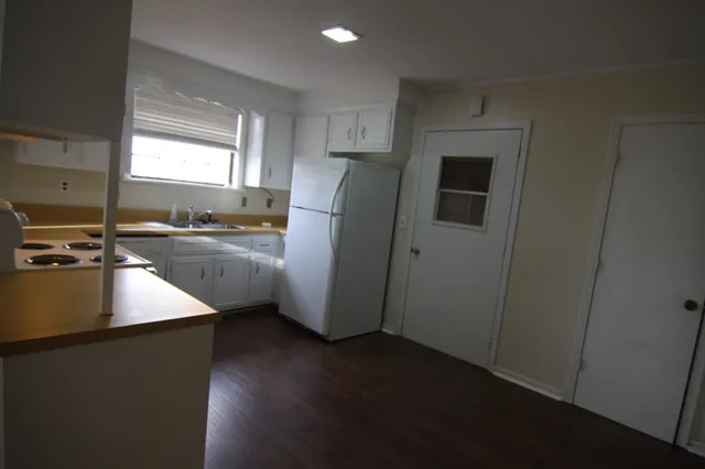 a kitchen with a refrigerator and a sink