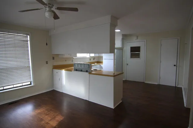 a kitchen with a refrigerator and a stove top oven