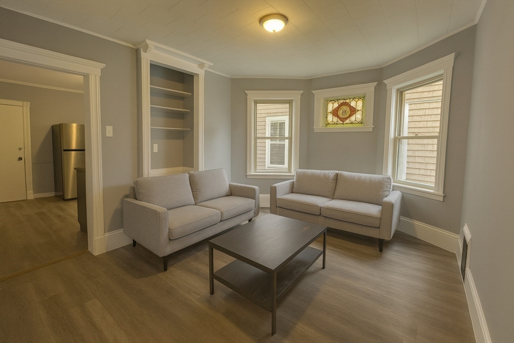 18 Chase Street, Unit 1 Boston, MA 02125 - Photo 1 of 10 a living room with furniture and a window