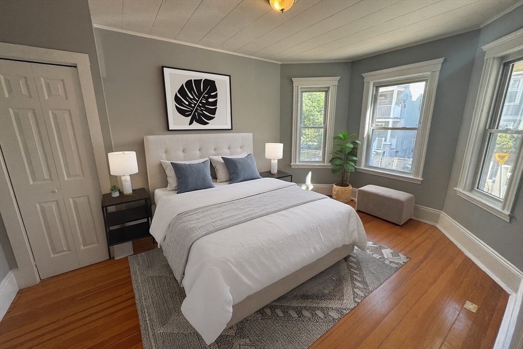 18 Chase Street, Unit 1 Boston, MA 02125 - Photo 4 of 10 a bedroom with a bed and a window