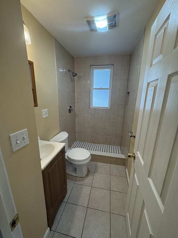 18 Chase Street, Unit 1 Boston, MA 02125 - Photo 8 of 10 a bathroom with a sink a toilet and a mirror