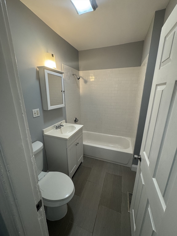 18 Chase Street, Unit 1 Boston, MA 02125 - Photo 9 of 10 a bathroom with a sink toilet and shower