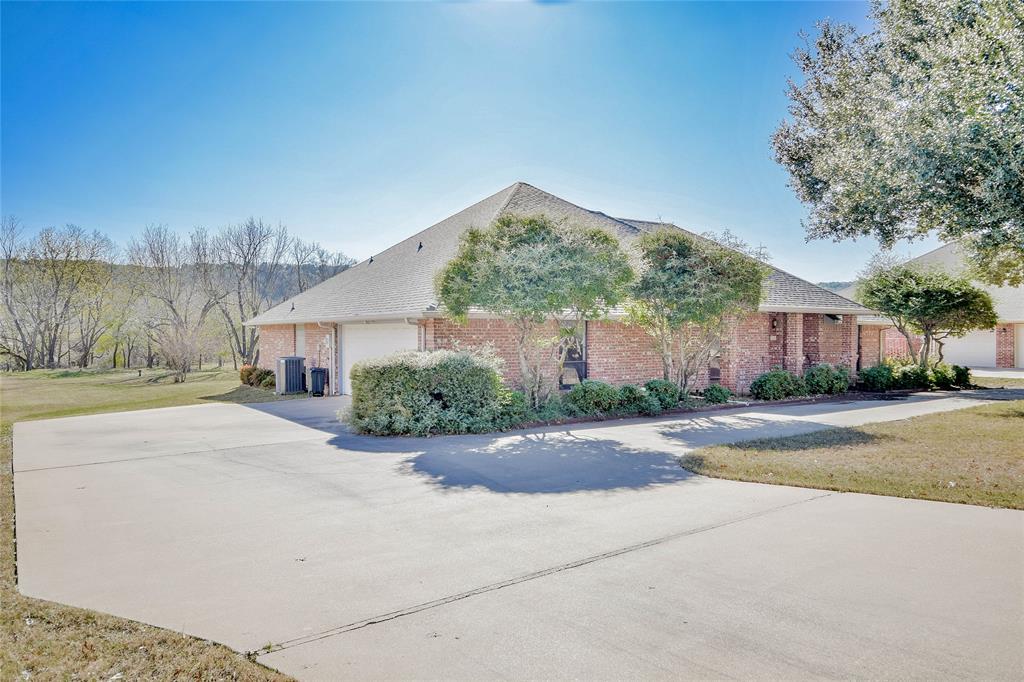 9110 Ravenswood Road Granbury, TX 76049 - Photo 2 of 40 Concrete driveway with circular driveway for easy access