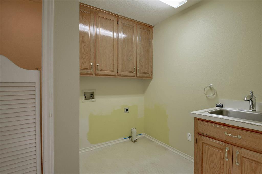 9110 Ravenswood Road Granbury, TX 76049 - Photo 22 of 40 Laundry room has sink and water closet