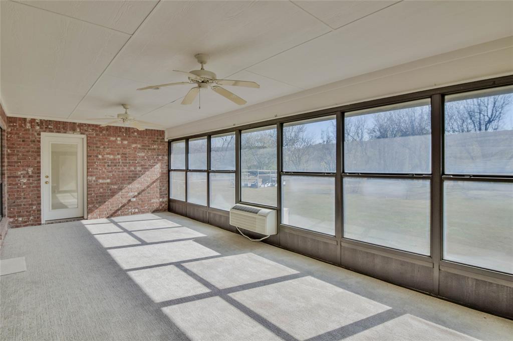 9110 Ravenswood Road Granbury, TX 76049 - Photo 32 of 40 Sunroom with ceiling fan and new carpet