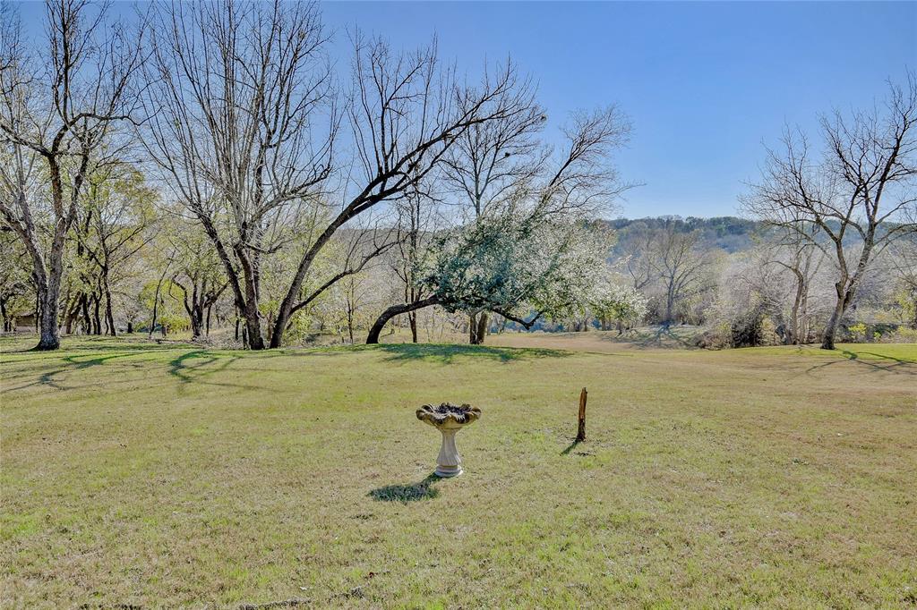 9110 Ravenswood Road Granbury, TX 76049 - Photo 36 of 40 Yard with mature trees and gentle slope to the Brazos River