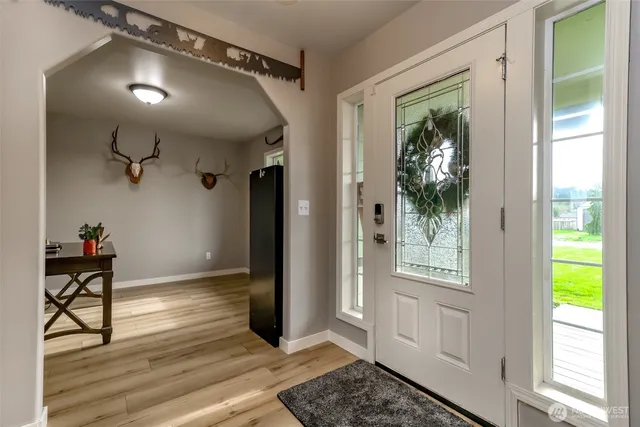 a view of a dining room with furniture and wooden floor