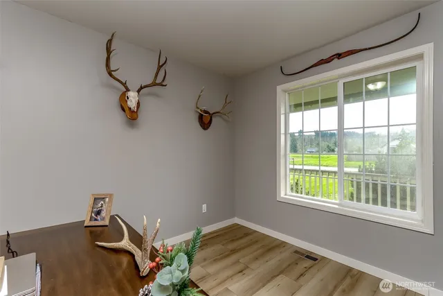 a view of a dining room with furniture a chandelier and wooden floor
