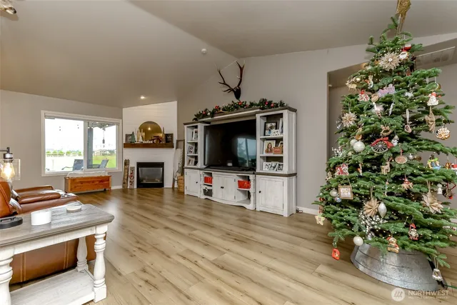 a dining room with stainless steel appliances kitchen island granite countertop a table chairs and a refrigerator